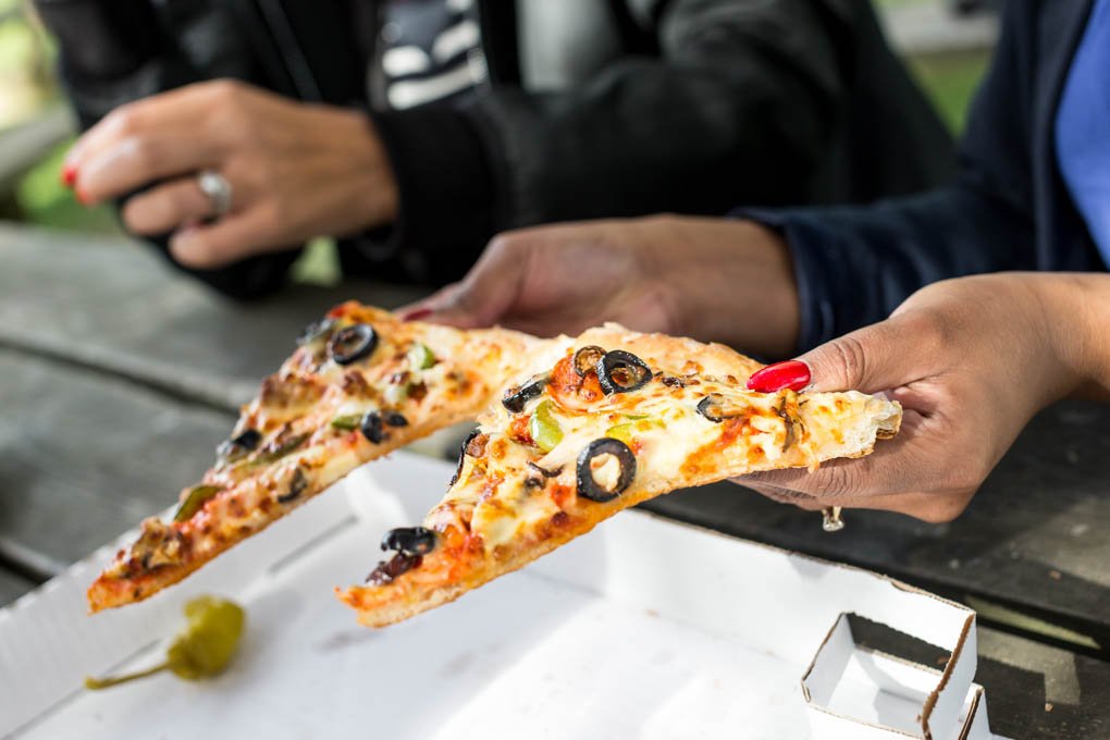 Papa Johns Pizza Hand Holding Slice